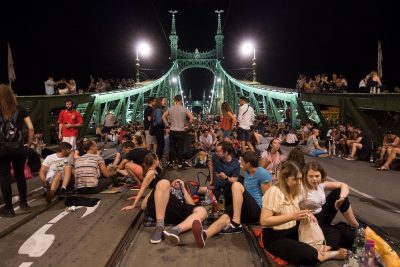 people sitting on Liberty Bridge when closed off